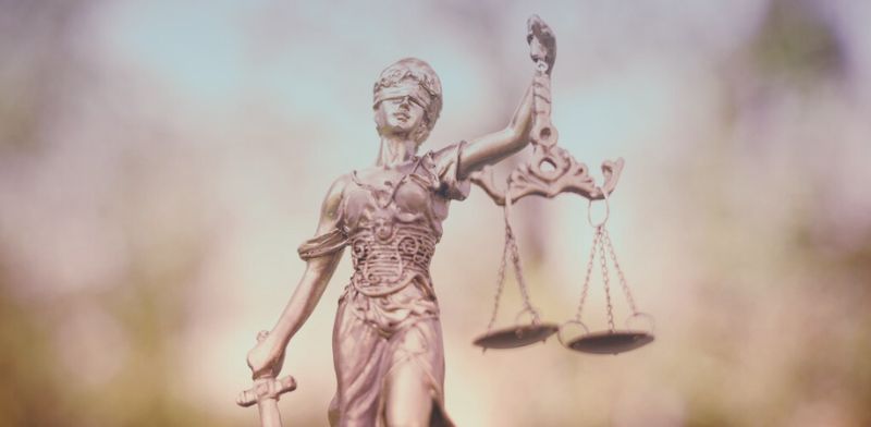 Statue d'une femme dont les yeux sont bandés représentant le caract justice. 